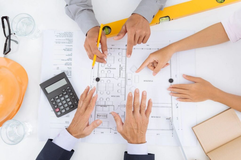 Team reviewing a floor plan together at a table