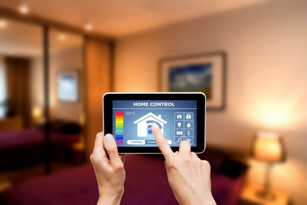 Hands using a smart home control app on a tablet